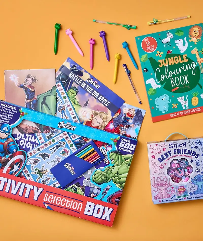 A colorful assortment of children’s activity items arranged on a yellow background, including an Avengers activity box with stickers and pencils, a jungle colouring book, decorative pens, and a Stitch-themed craft set.